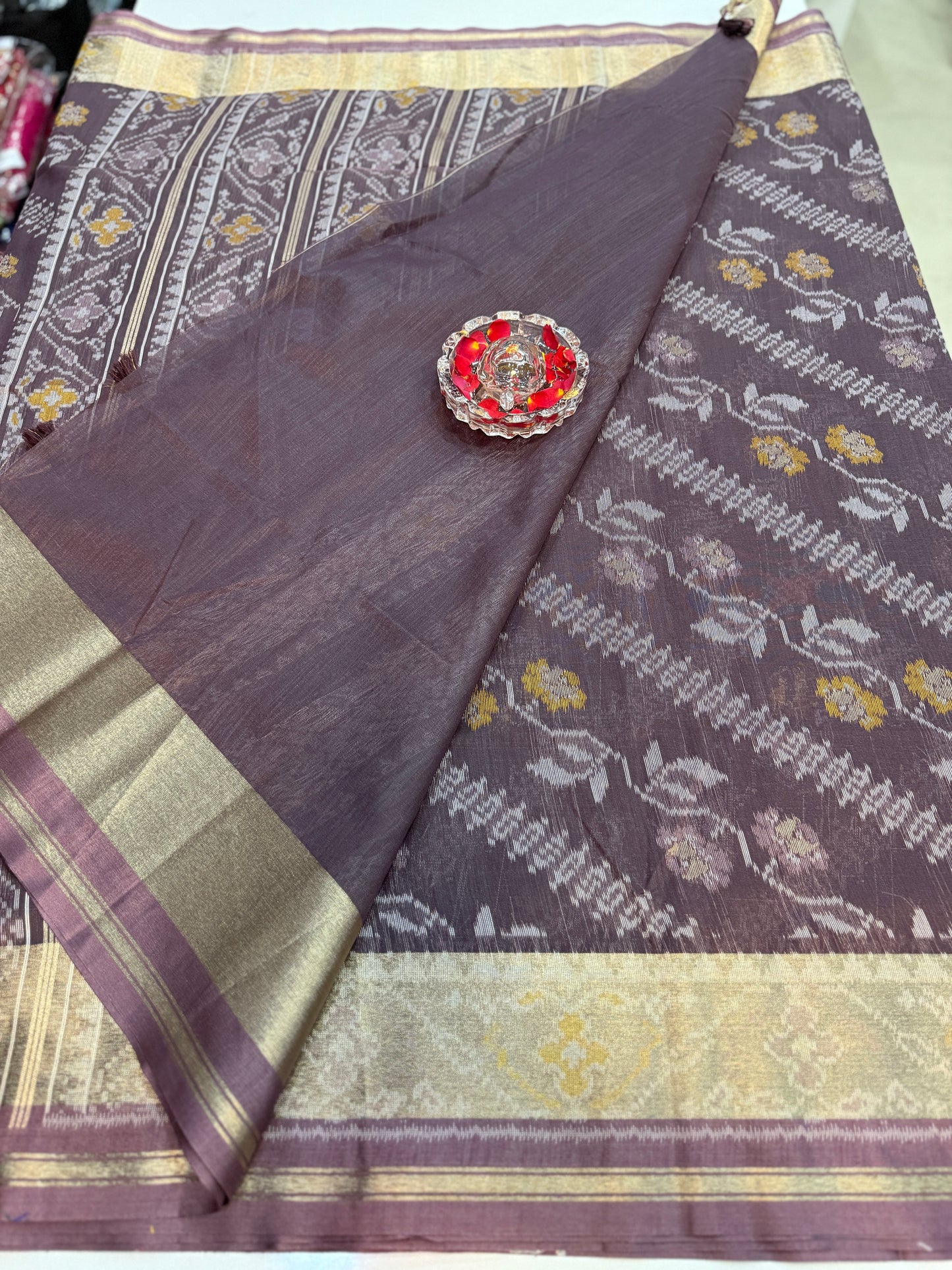 Women’s ikat style woven saree with contrast border and tassel pallu