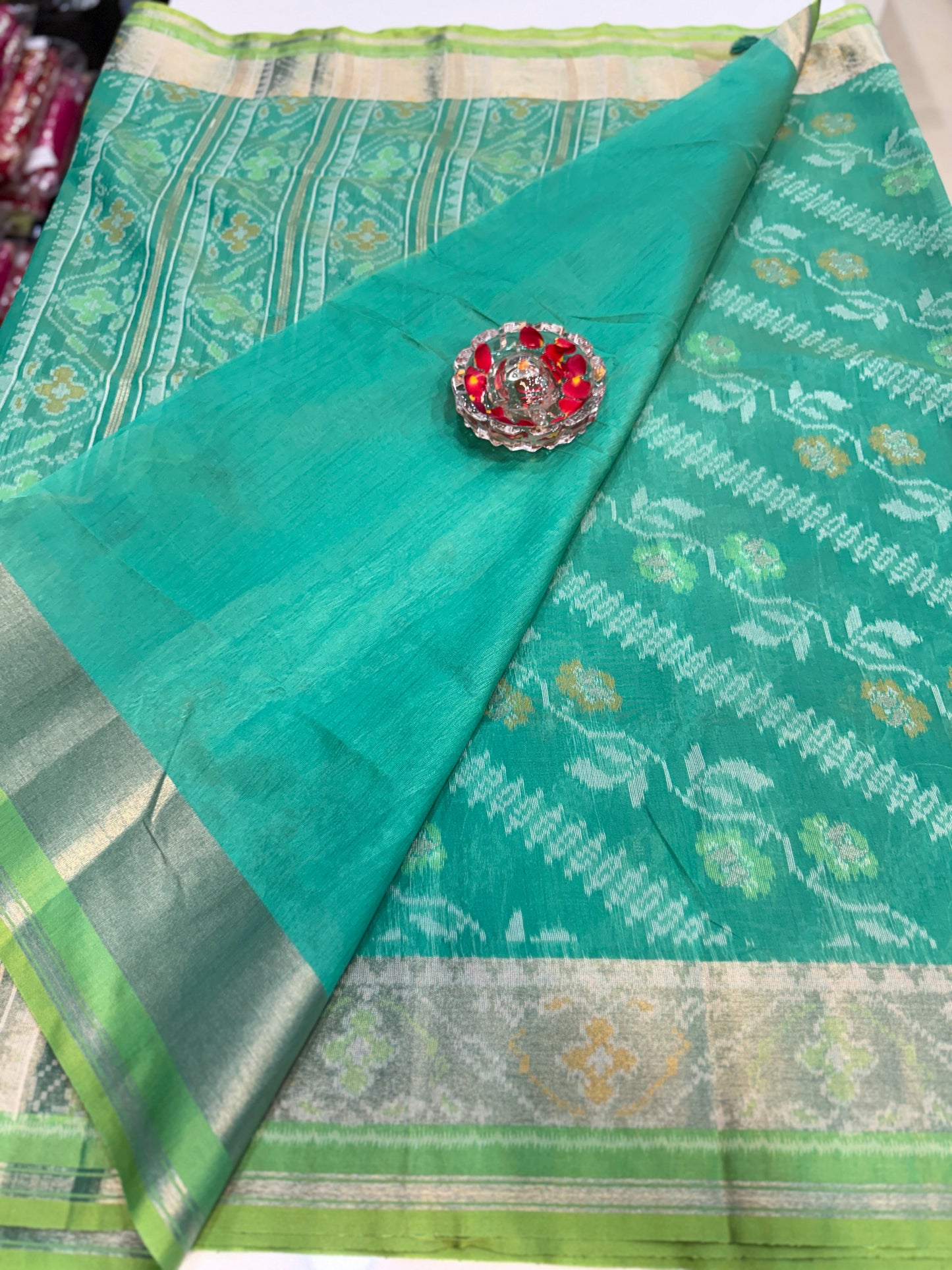 Women’s ikat style woven saree with contrast border and tassel pallu