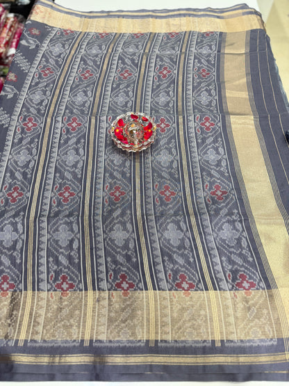 Women’s ikat style woven saree with contrast border and tassel pallu