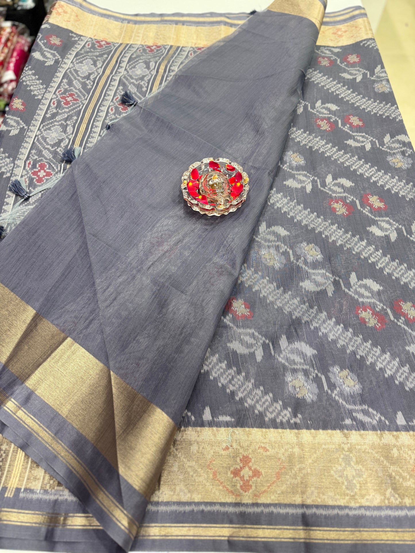 Women’s ikat style woven saree with contrast border and tassel pallu