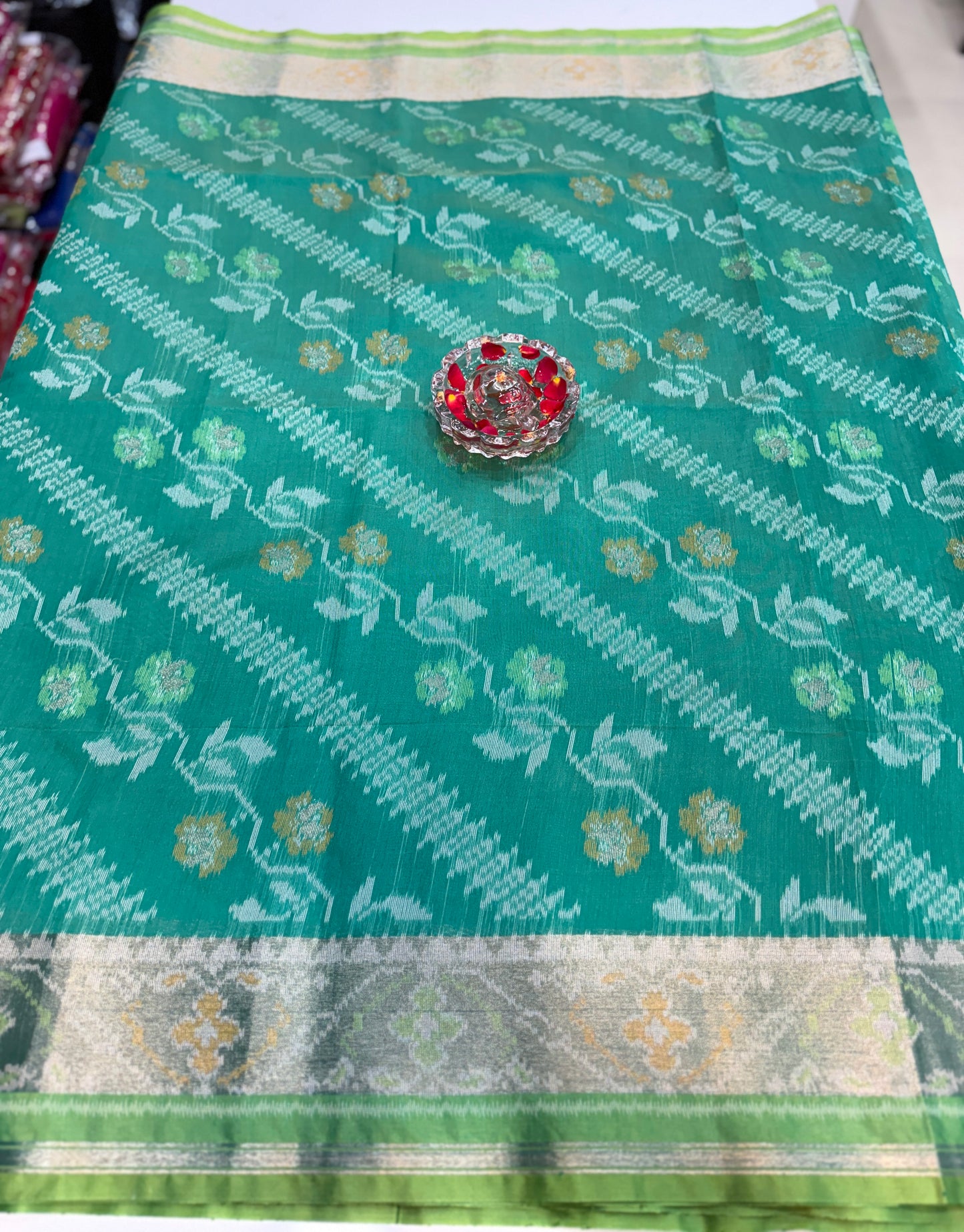 Women’s ikat style woven saree with contrast border and tassel pallu