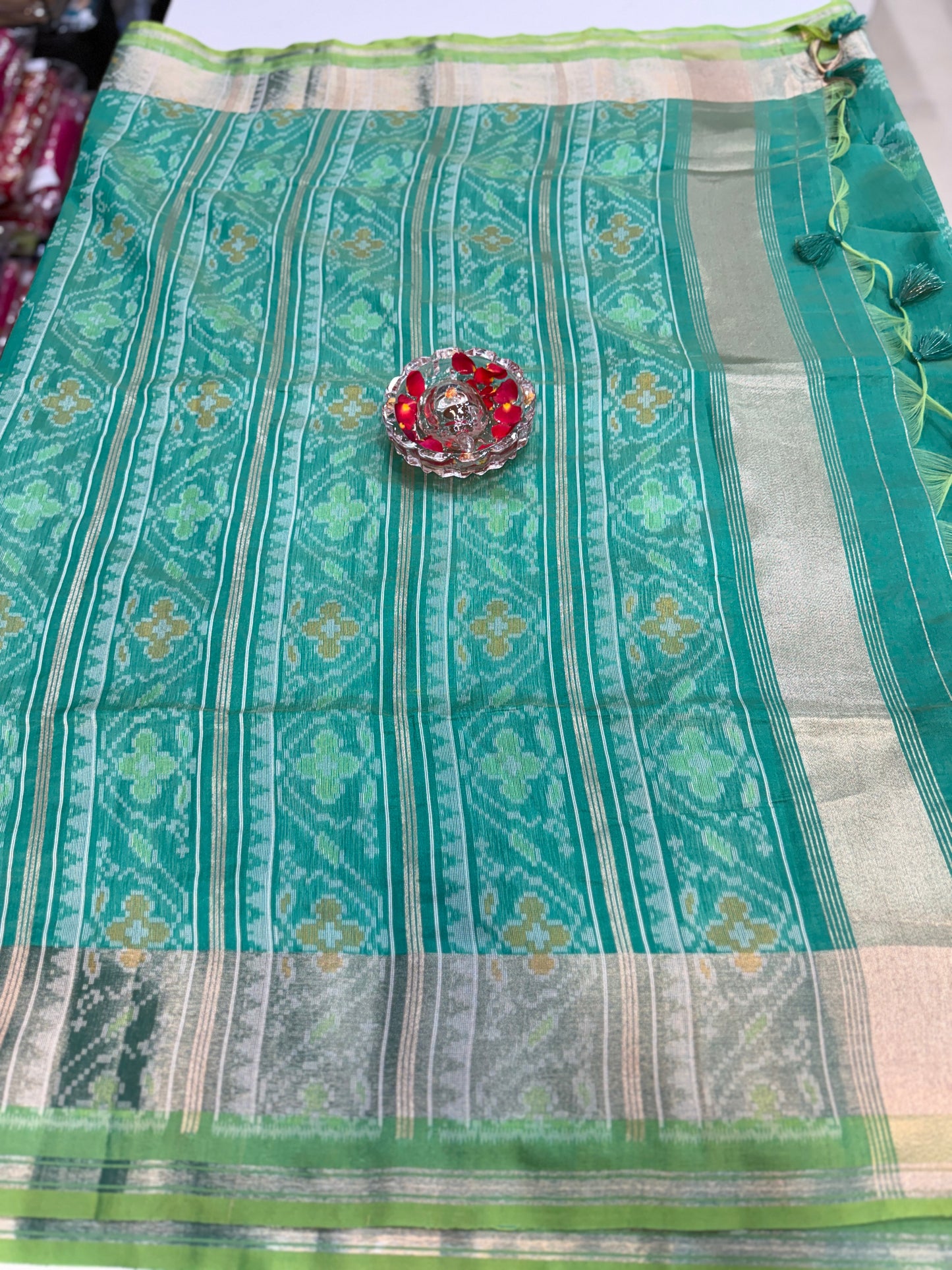 Women’s ikat style woven saree with contrast border and tassel pallu