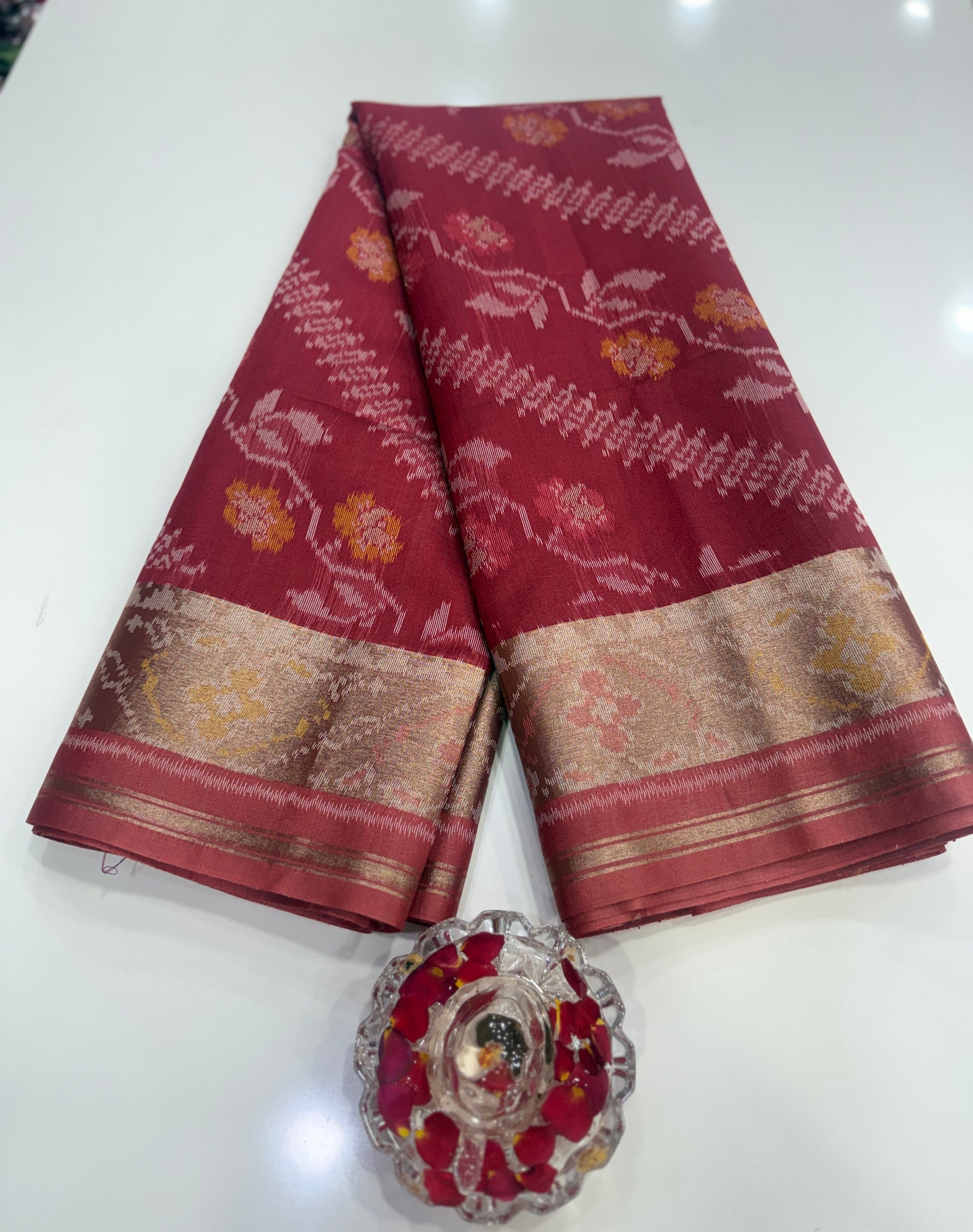 Women’s ikat style woven saree with contrast border and tassel pallu