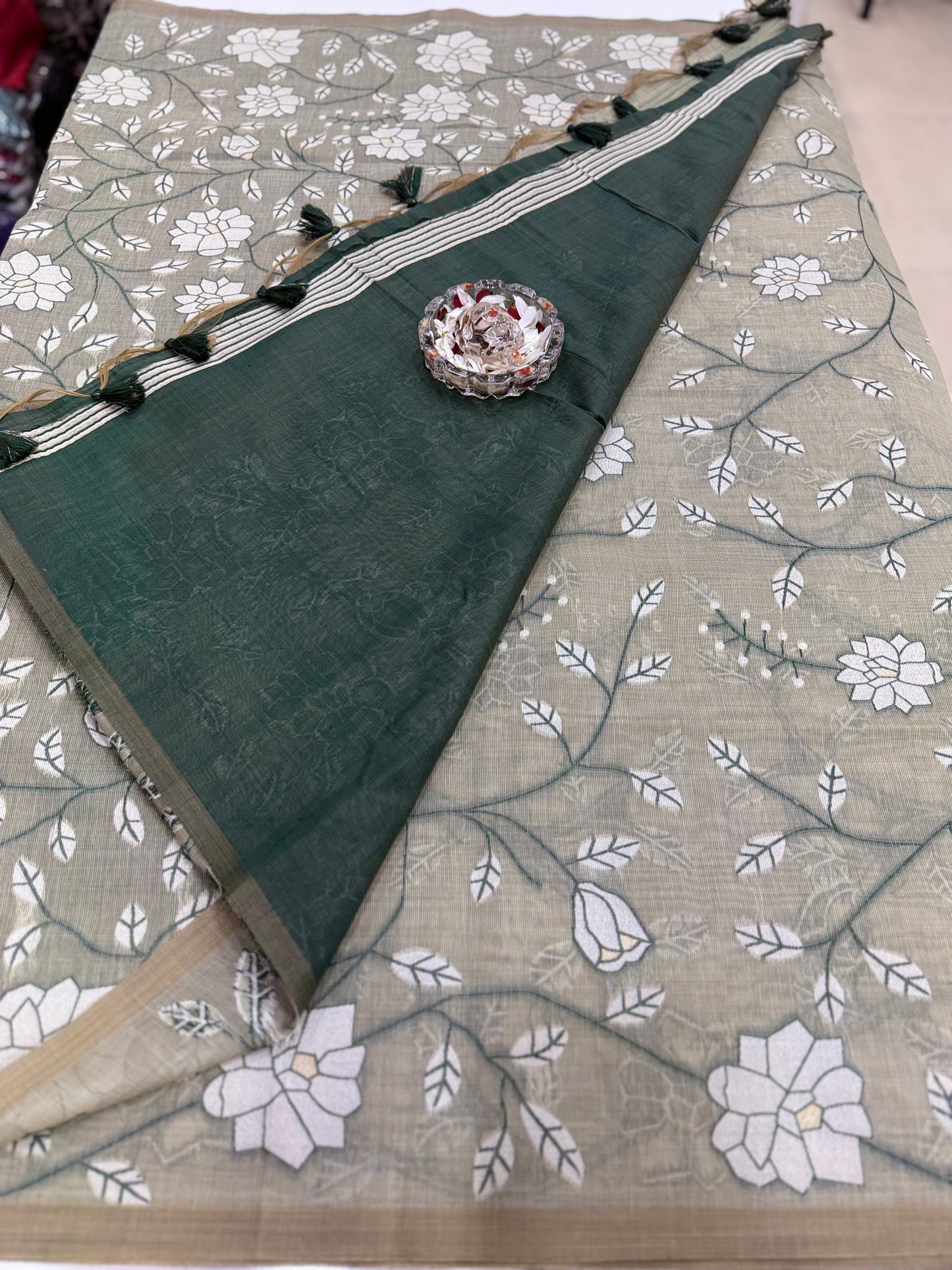 Linen printed saree with floral vine design, contrast border and tassel pallu, women’s daily wear saree
