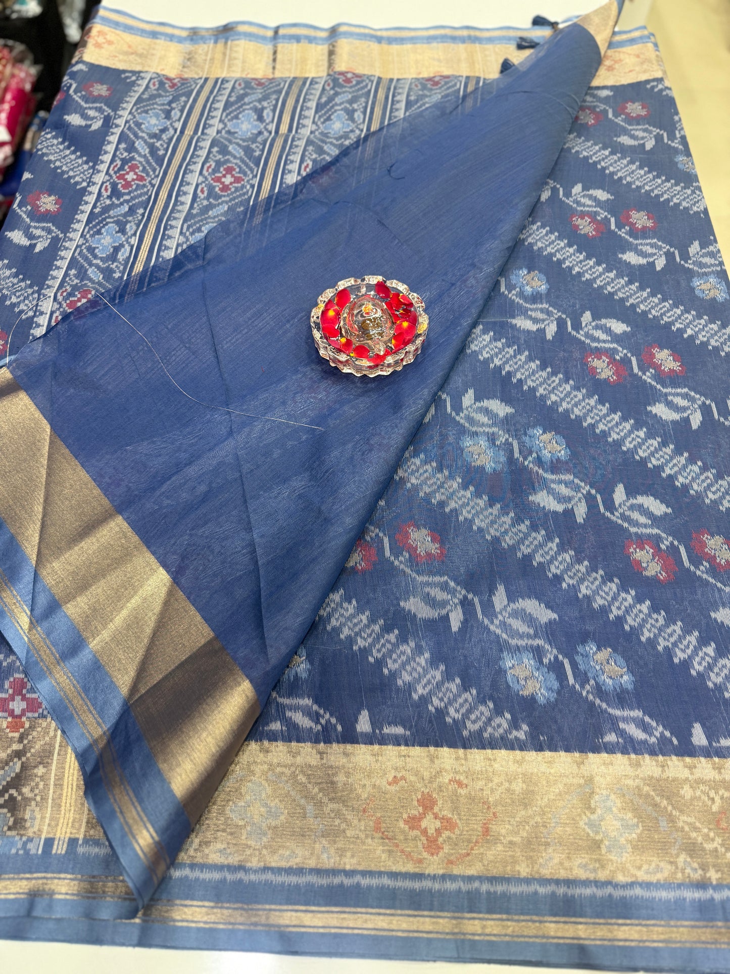 Women’s ikat style woven saree with contrast border and tassel pallu