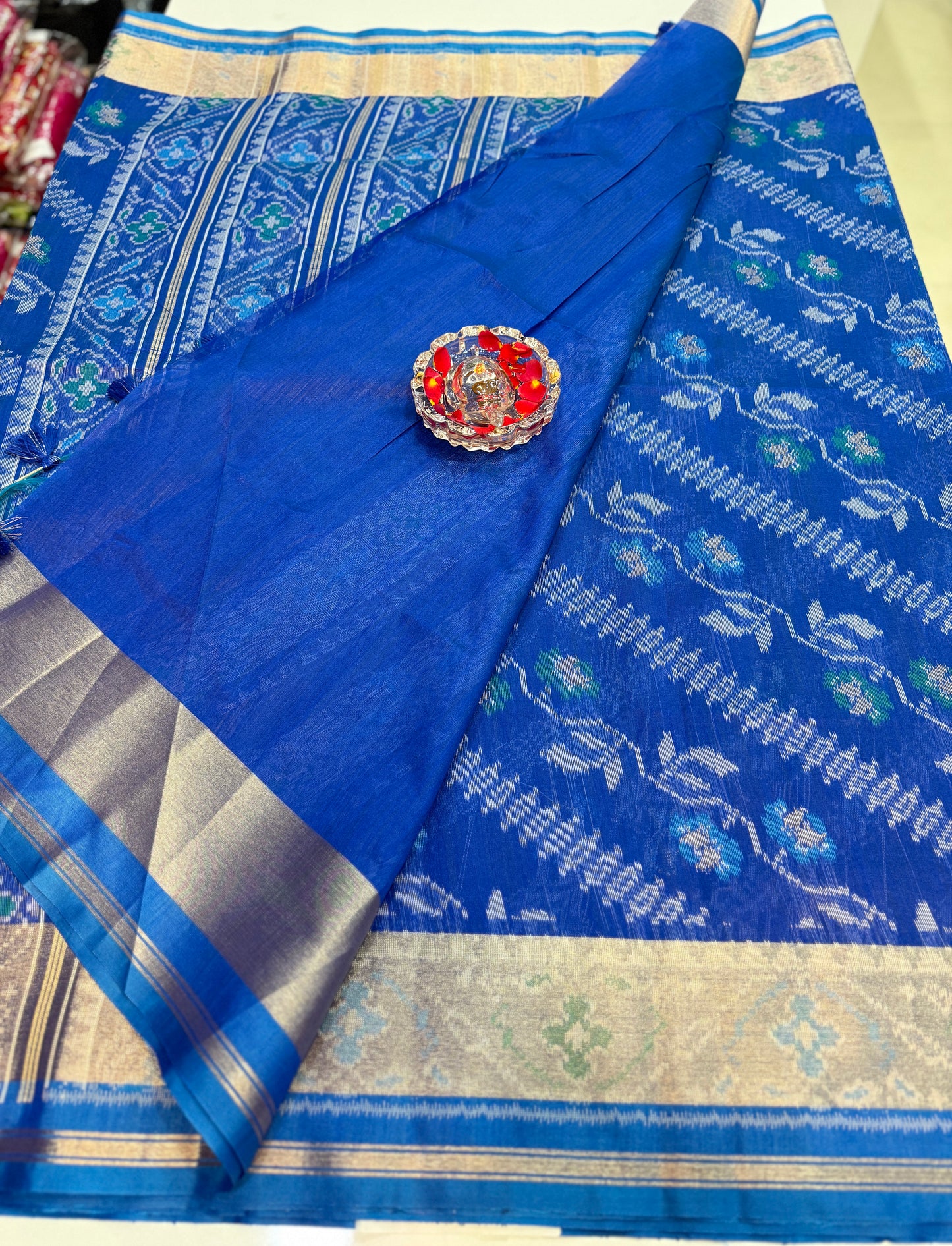 Women’s ikat style woven saree with contrast border and tassel pallu