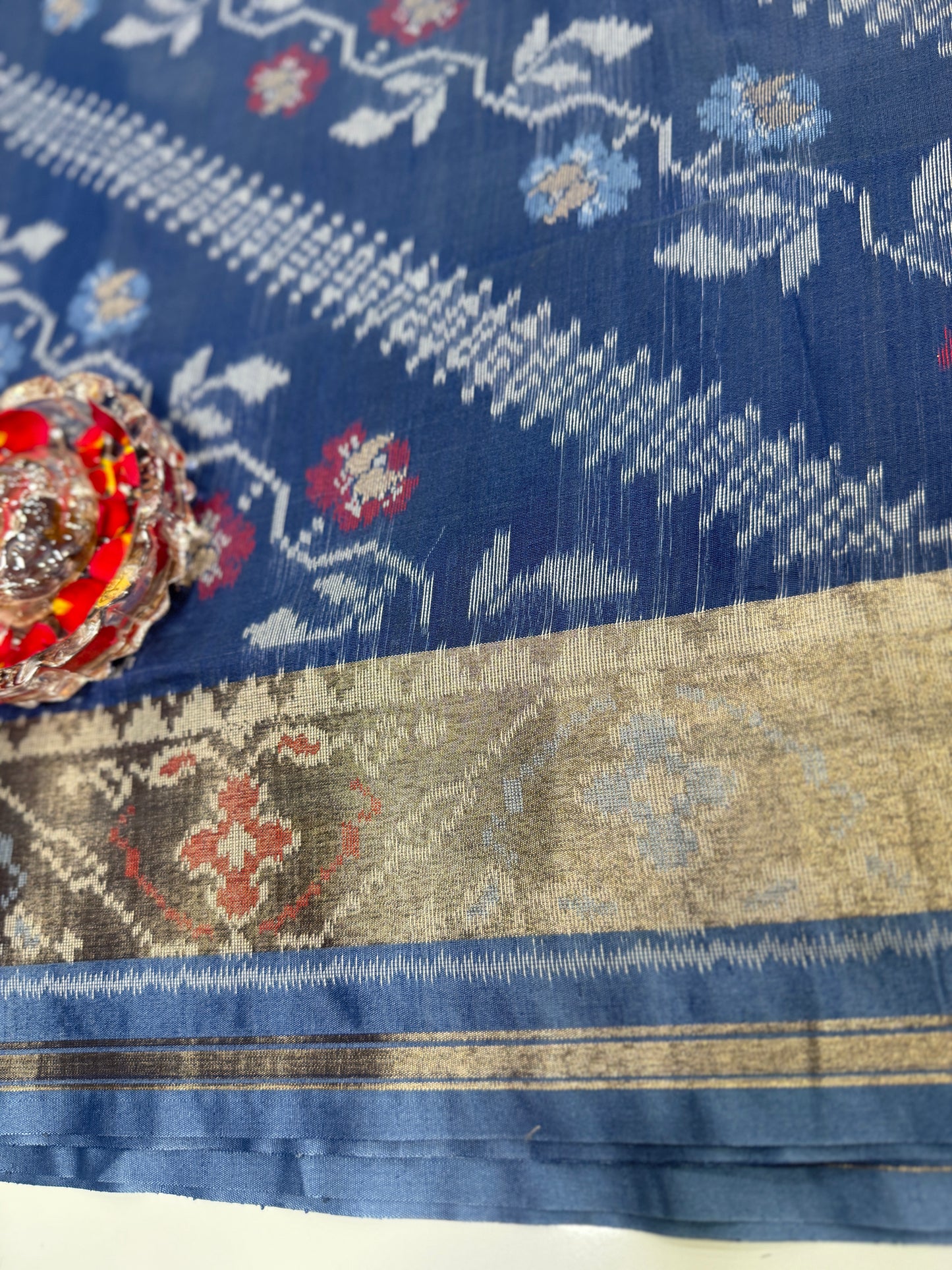 Women’s ikat style woven saree with contrast border and tassel pallu