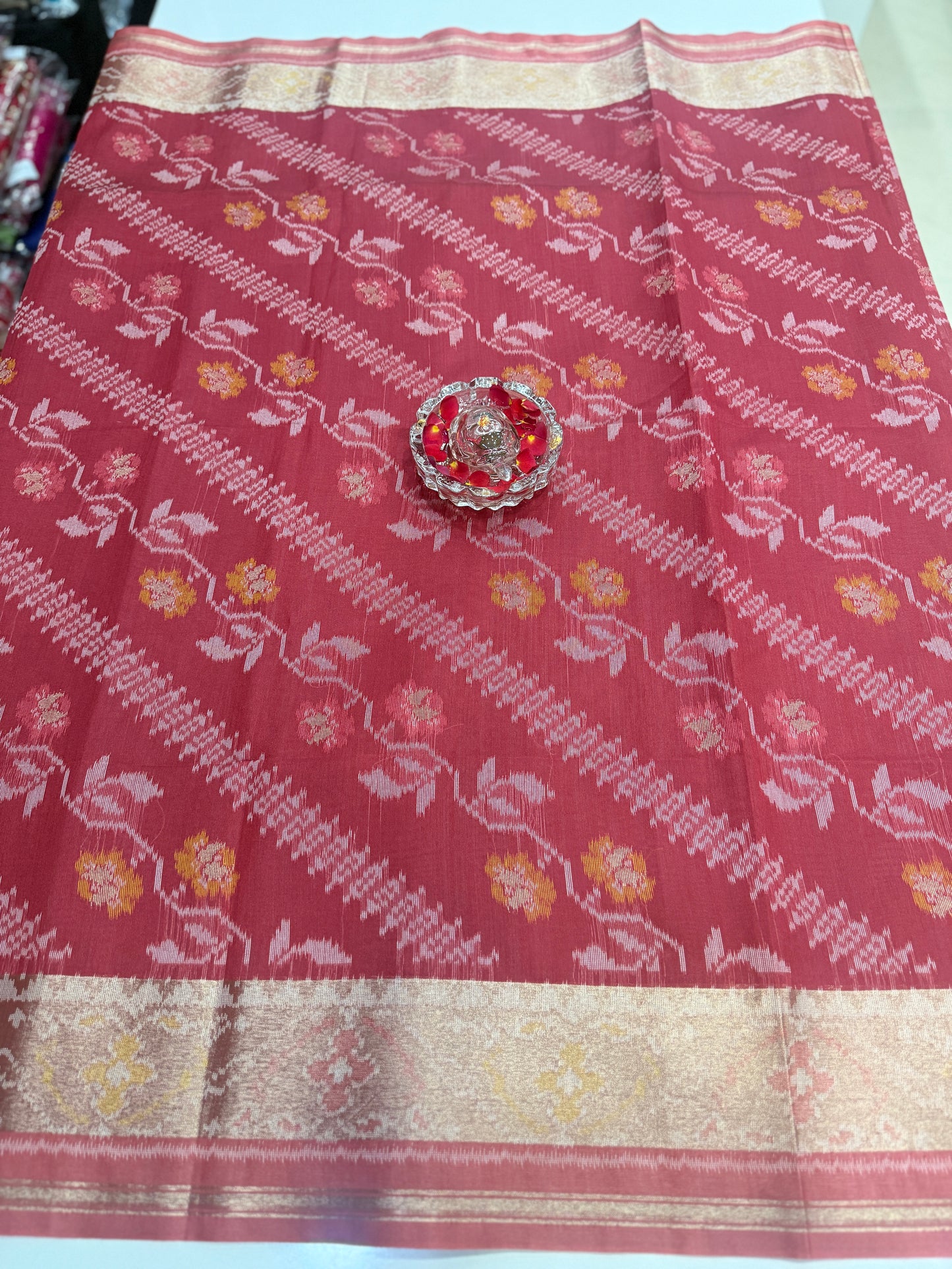 Women’s ikat style woven saree with contrast border and tassel pallu