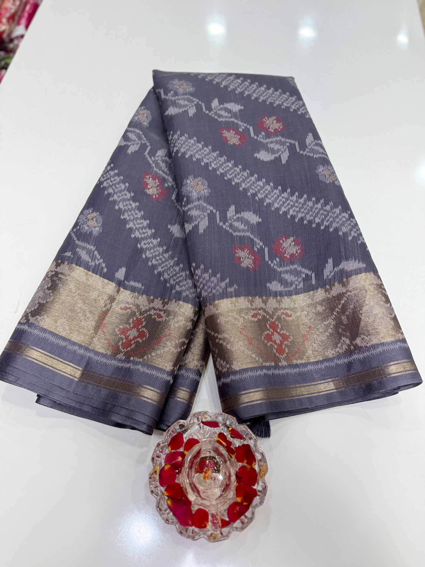 Women’s ikat style woven saree with contrast border and tassel pallu