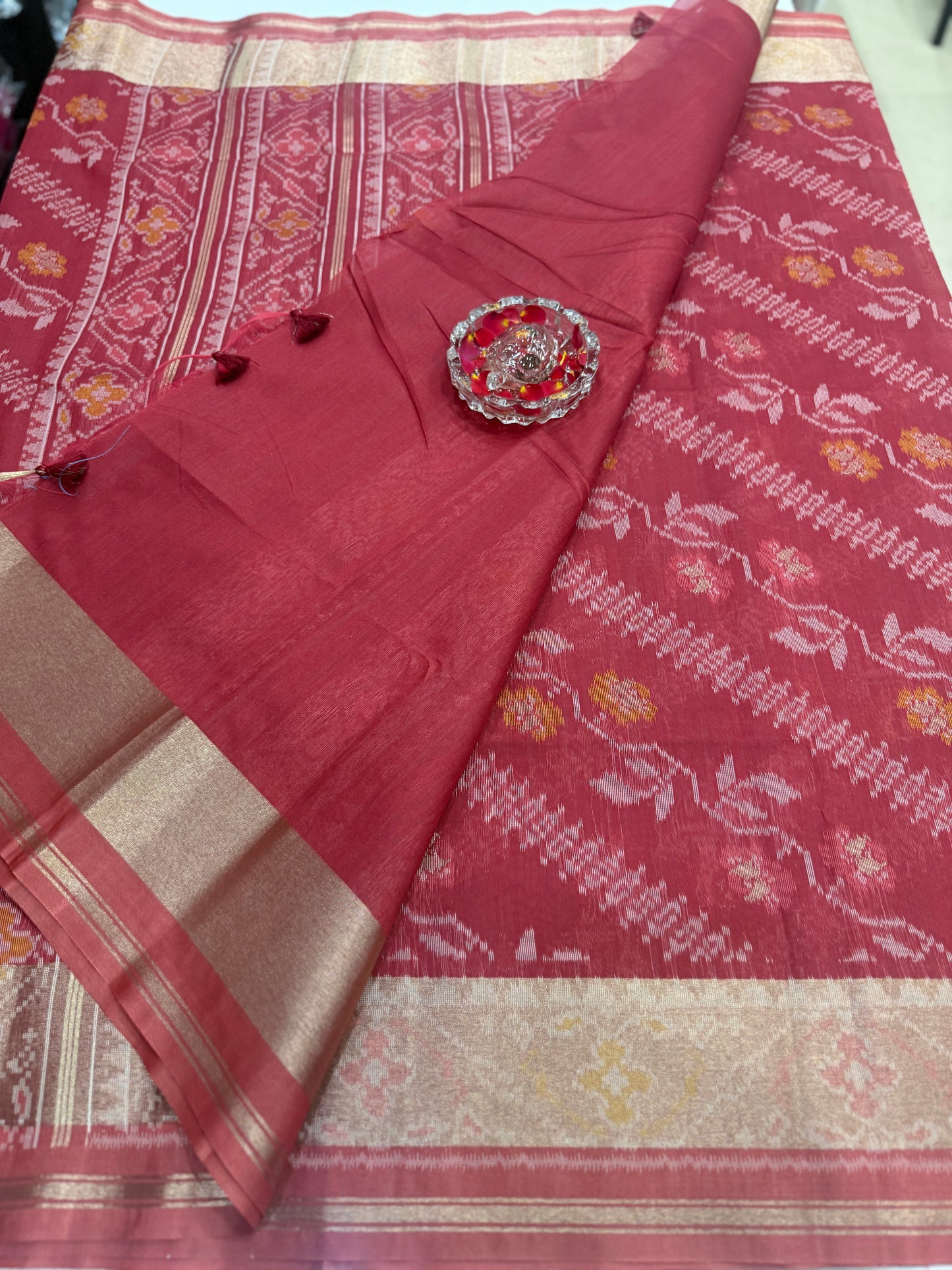 Women’s ikat style woven saree with contrast border and tassel pallu