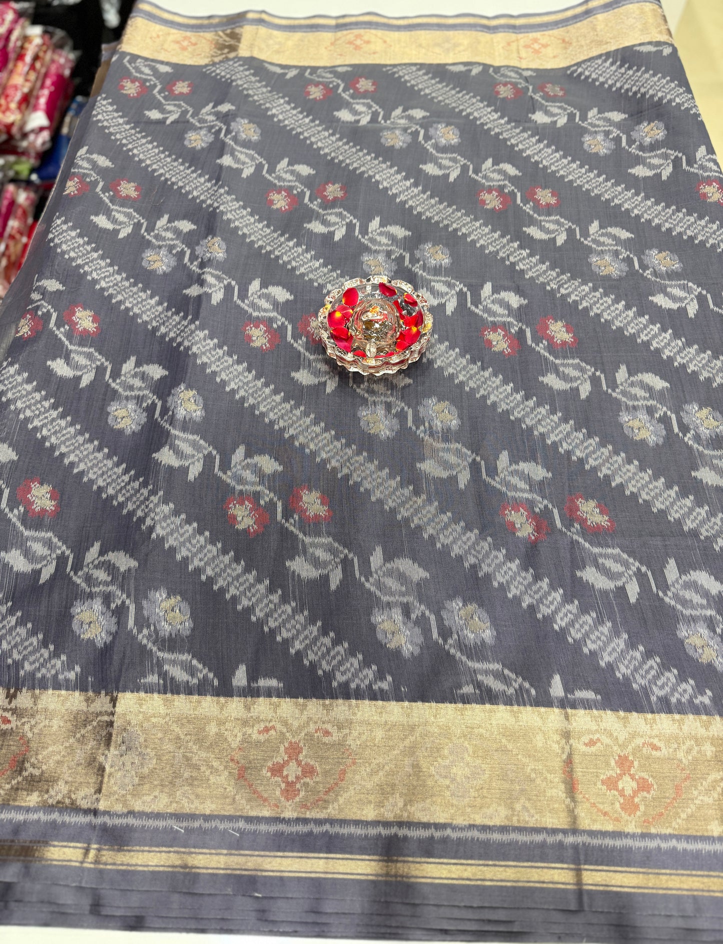 Women’s ikat style woven saree with contrast border and tassel pallu