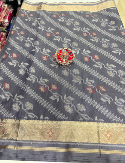 Women’s ikat style woven saree with contrast border and tassel pallu