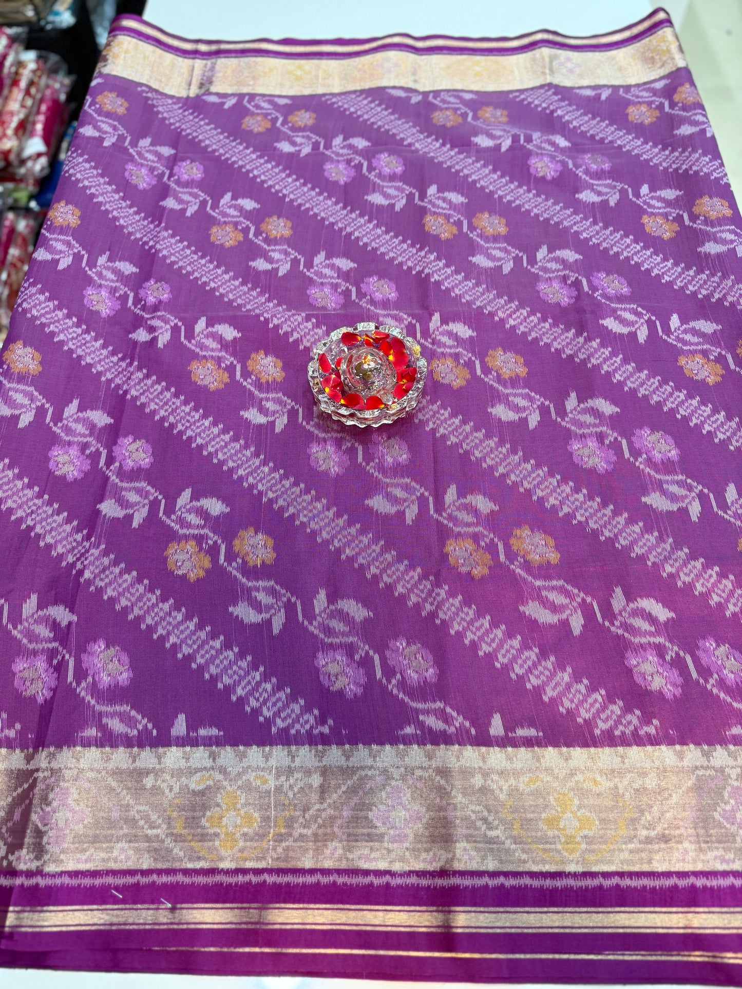 Women’s ikat style woven saree with contrast border and tassel pallu