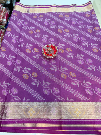 Women’s ikat style woven saree with contrast border and tassel pallu