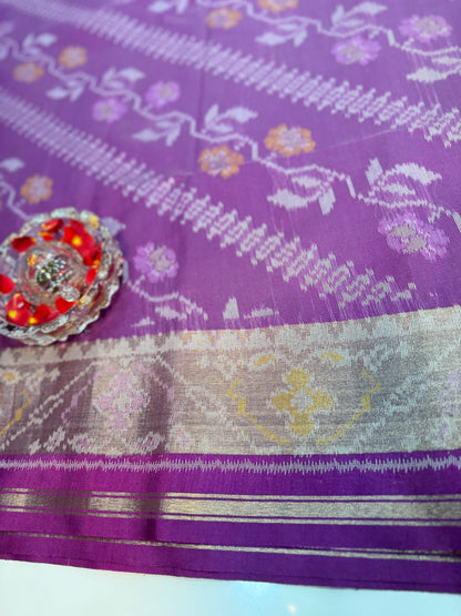 Women’s ikat style woven saree with contrast border and tassel pallu