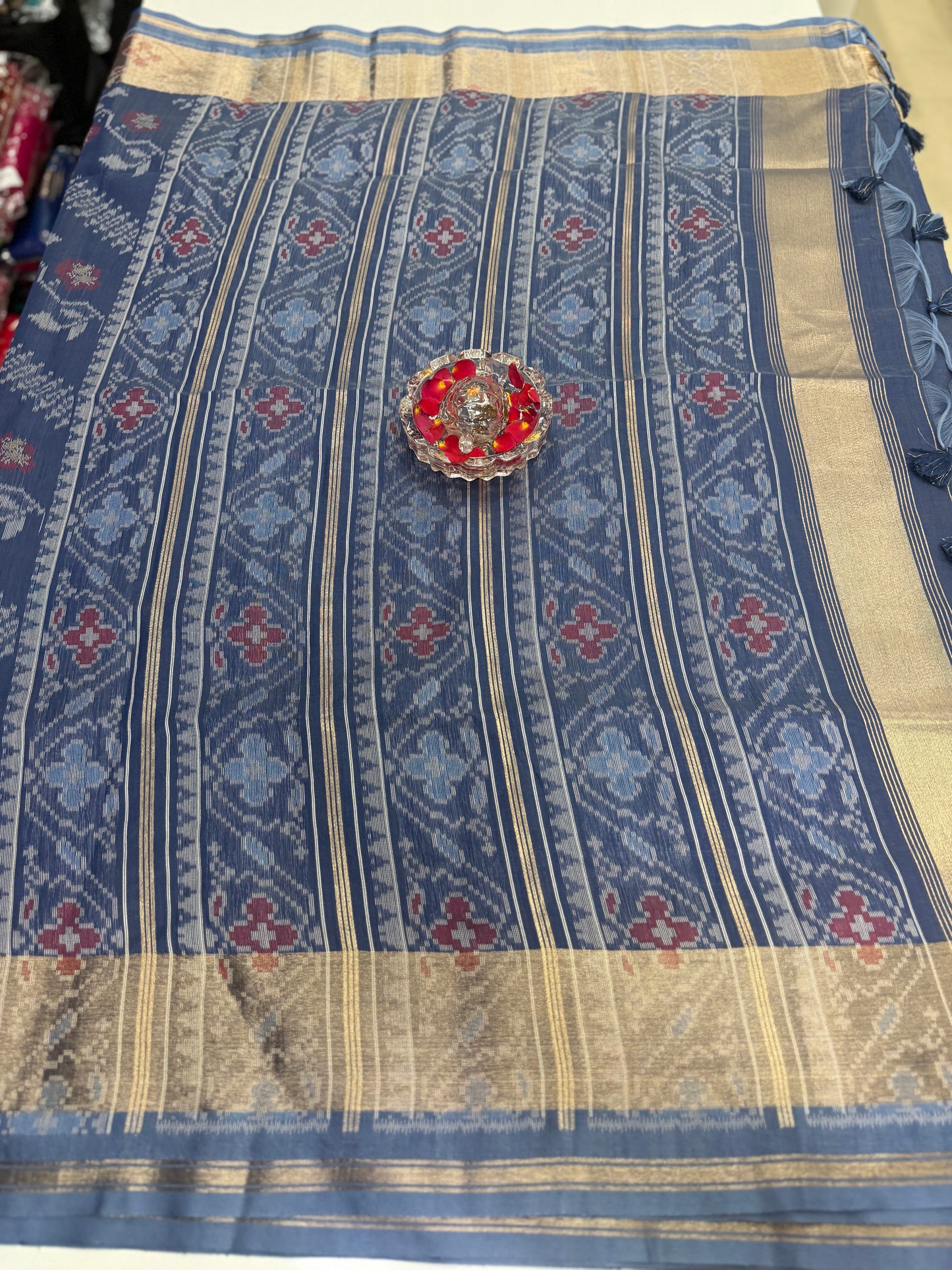 Women’s ikat style woven saree with contrast border and tassel pallu