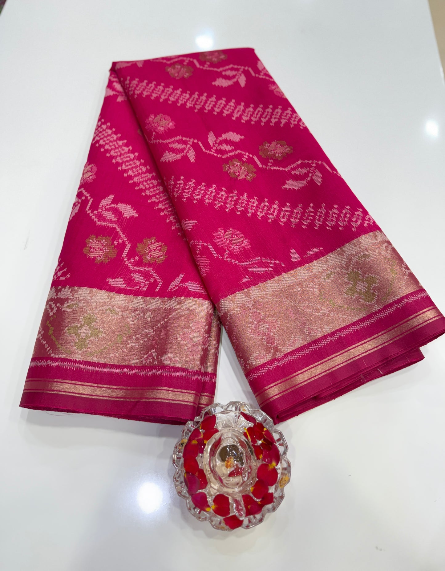 Women’s ikat style woven saree with contrast border and tassel pallu