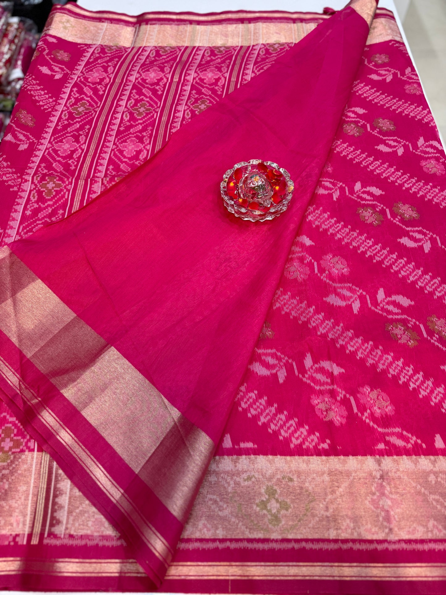 Women’s ikat style woven saree with contrast border and tassel pallu