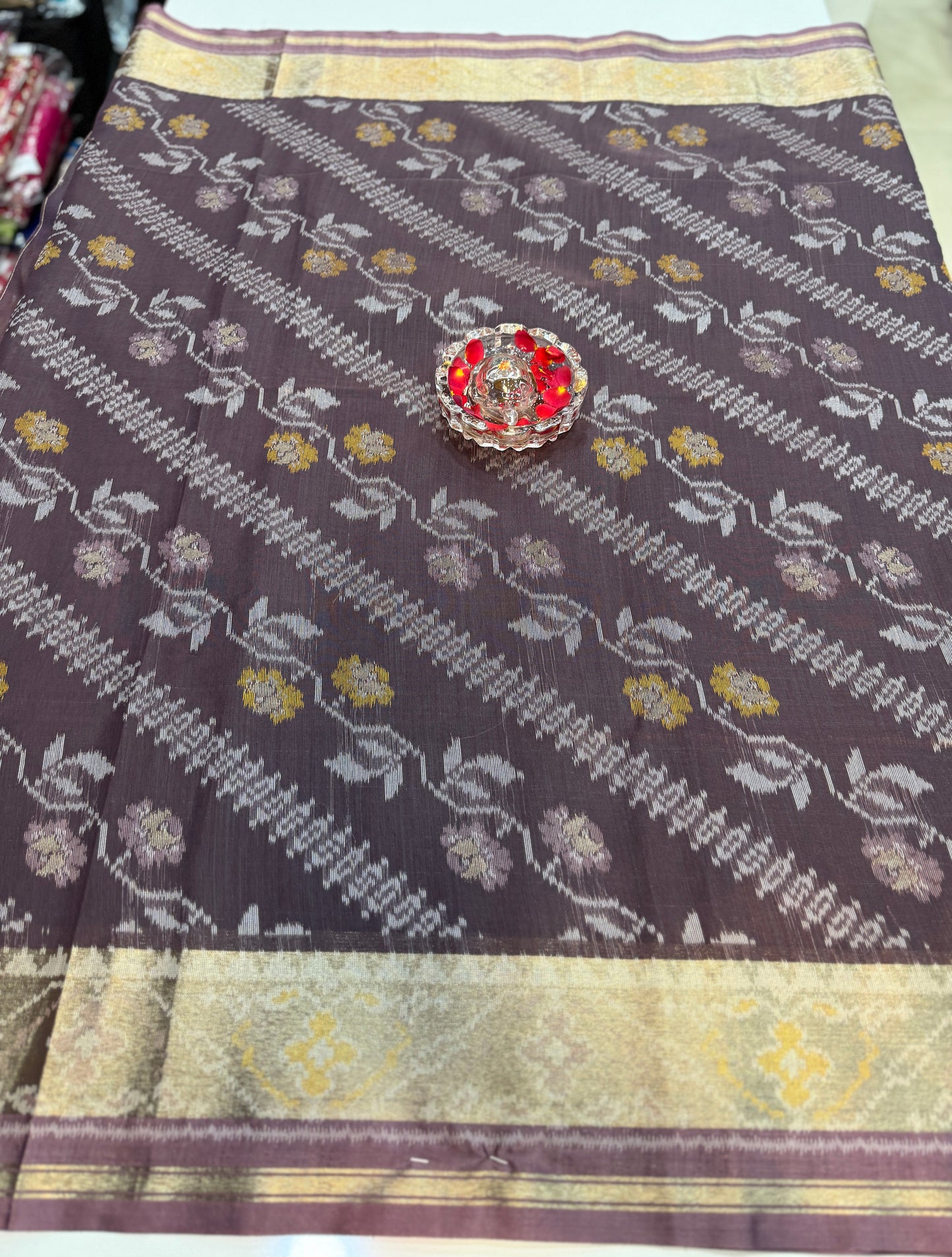 Women’s ikat style woven saree with contrast border and tassel pallu