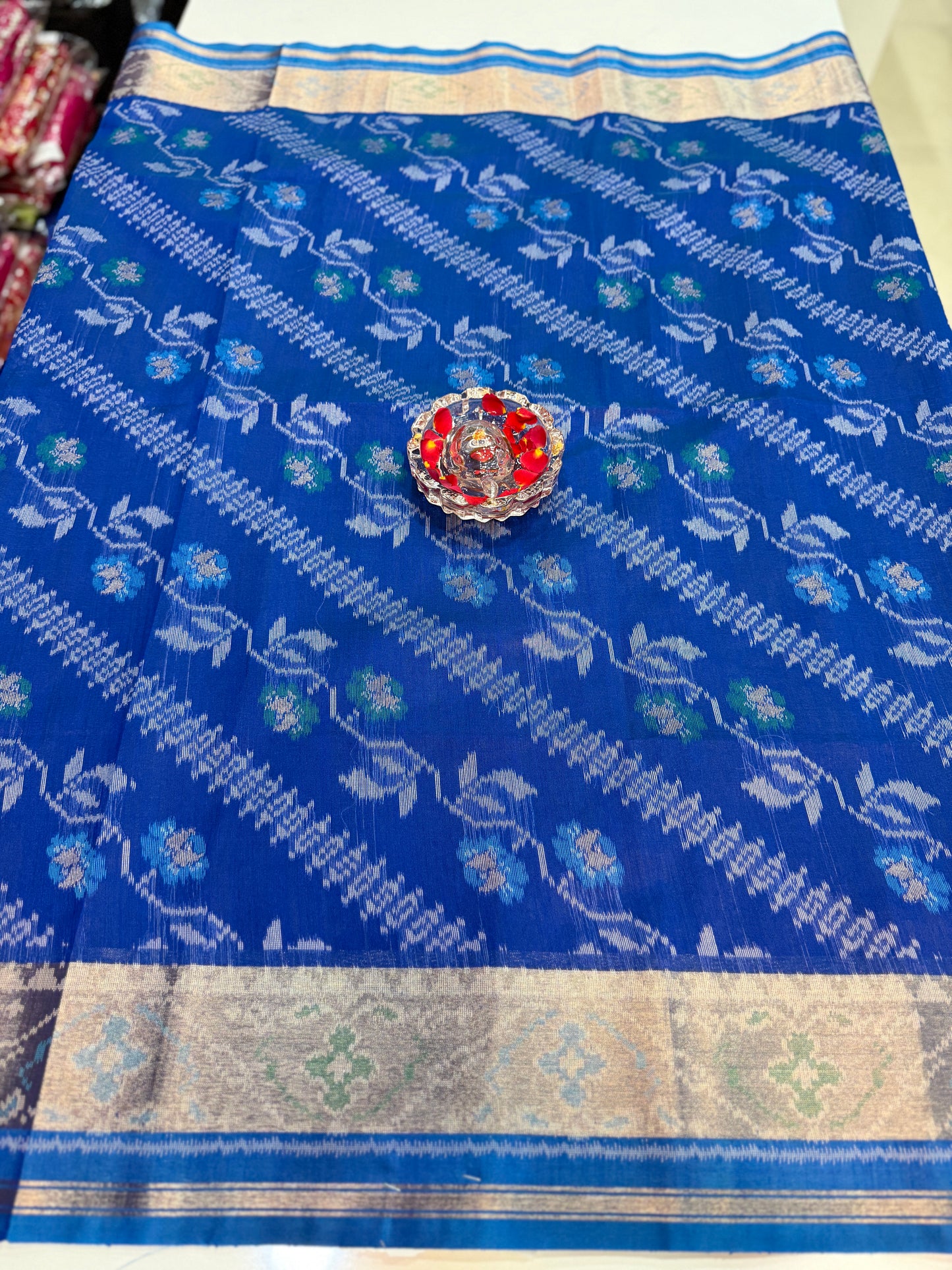 Women’s ikat style woven saree with contrast border and tassel pallu