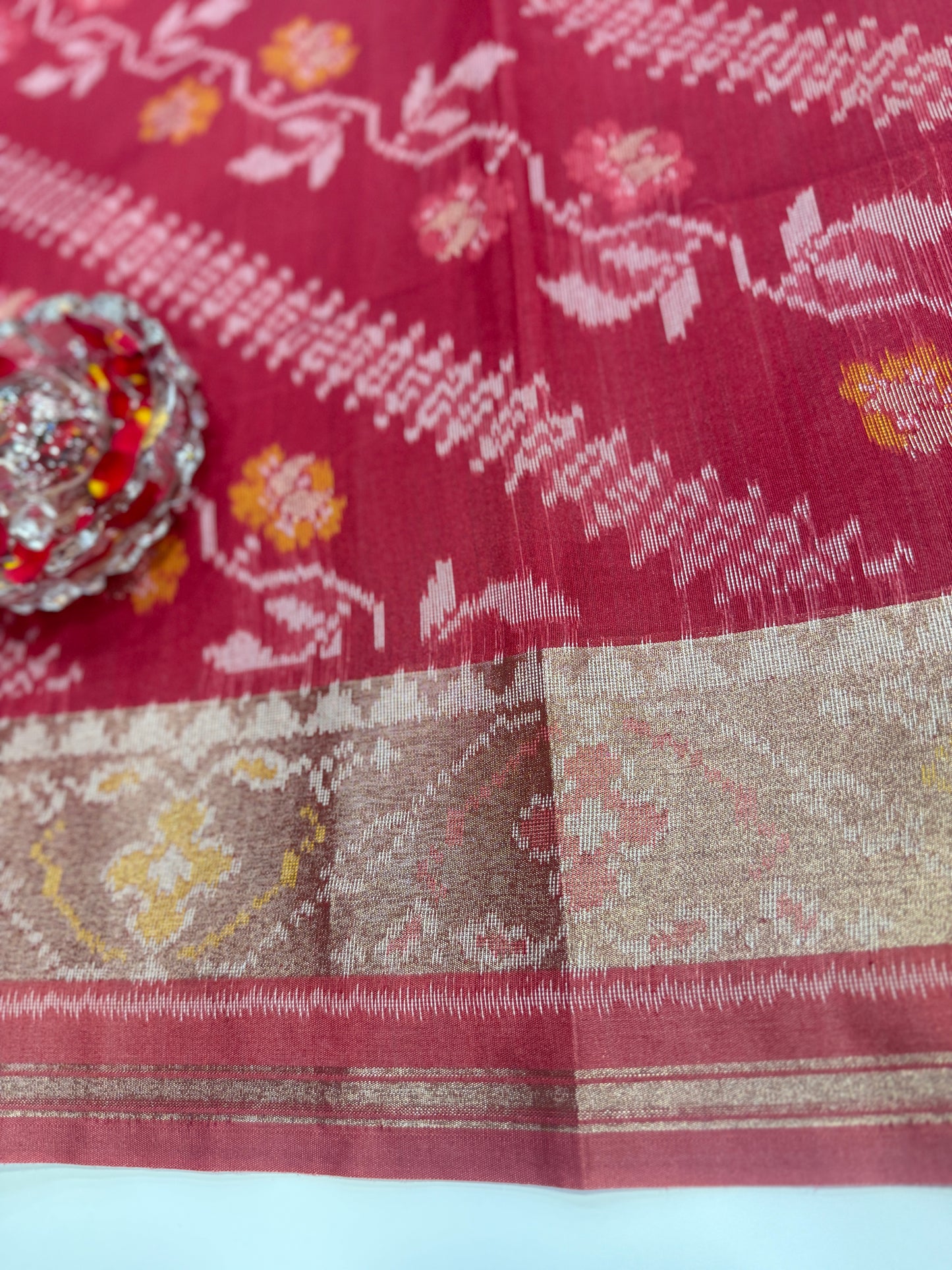 Women’s ikat style woven saree with contrast border and tassel pallu