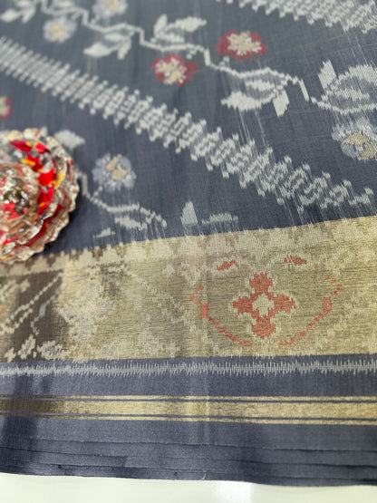 Women’s ikat style woven saree with contrast border and tassel pallu