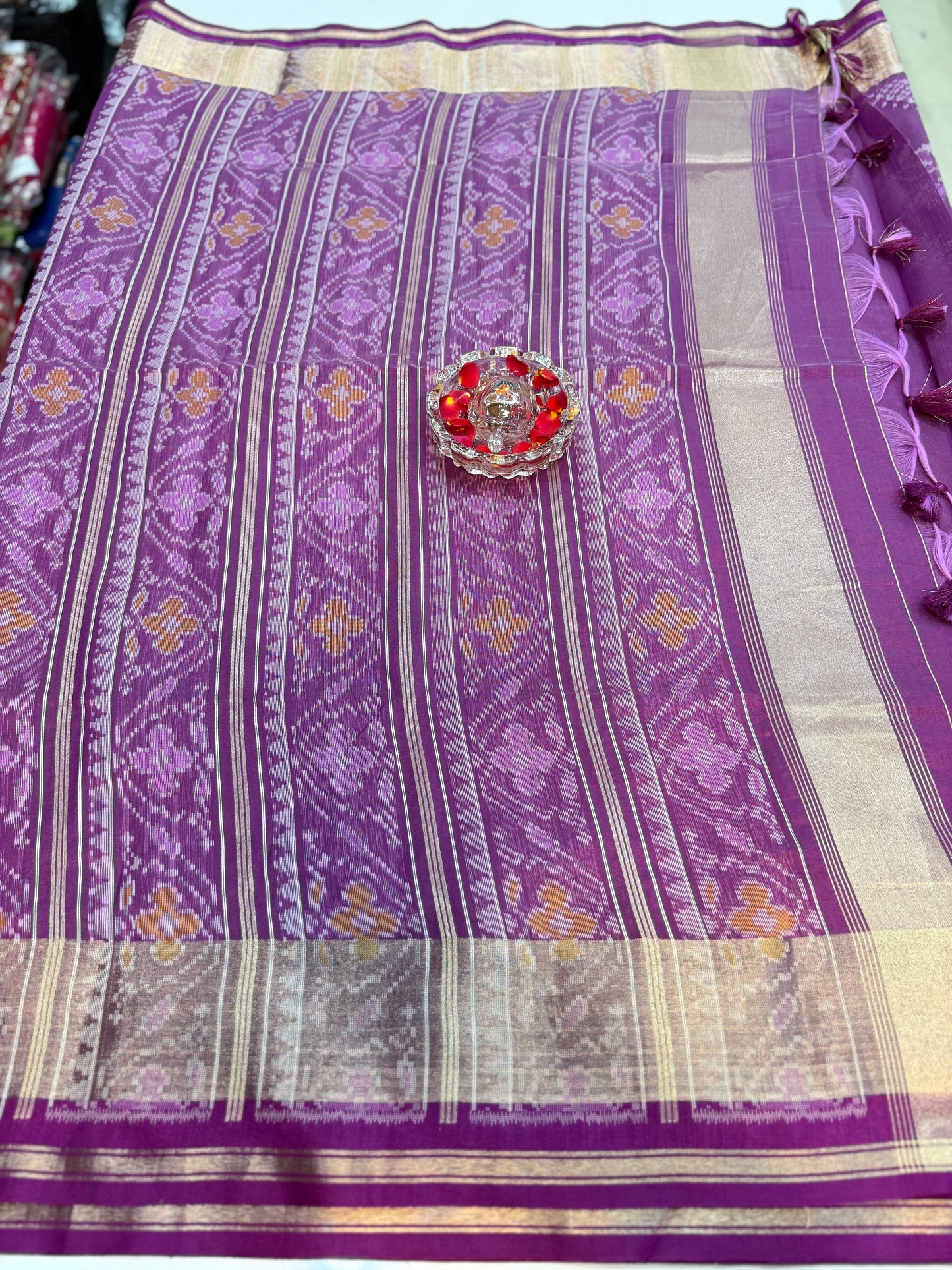 Women’s ikat style woven saree with contrast border and tassel pallu