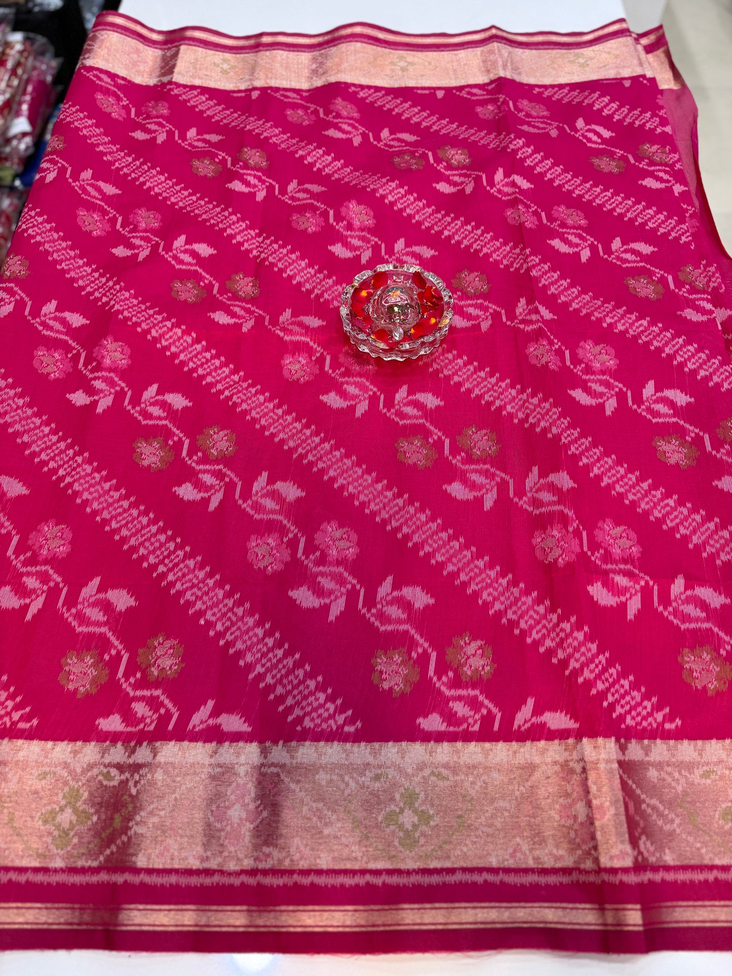 Women’s ikat style woven saree with contrast border and tassel pallu