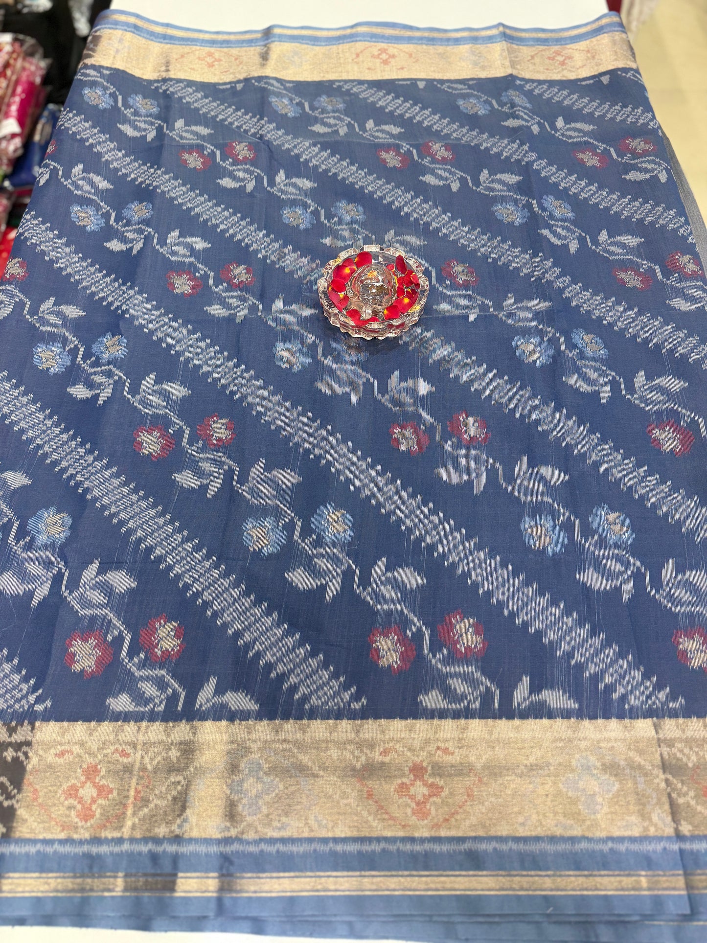 Women’s ikat style woven saree with contrast border and tassel pallu